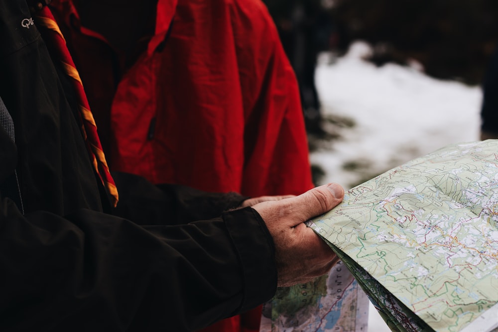 person holding green map