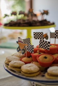 Close-up of delicious sweet treats and savory dishes displayed on a food truck counter during a birthday party.