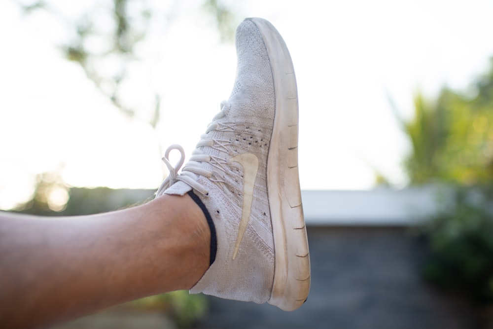 person wearing white nike air force 1 low