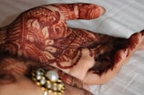 A vibrant henna tattoo on a bride's palm showcasing traditional floral patterns