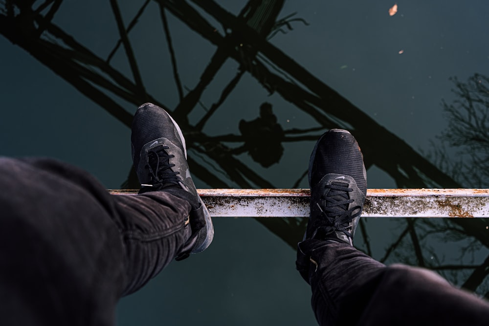 person standing on brown metal bar