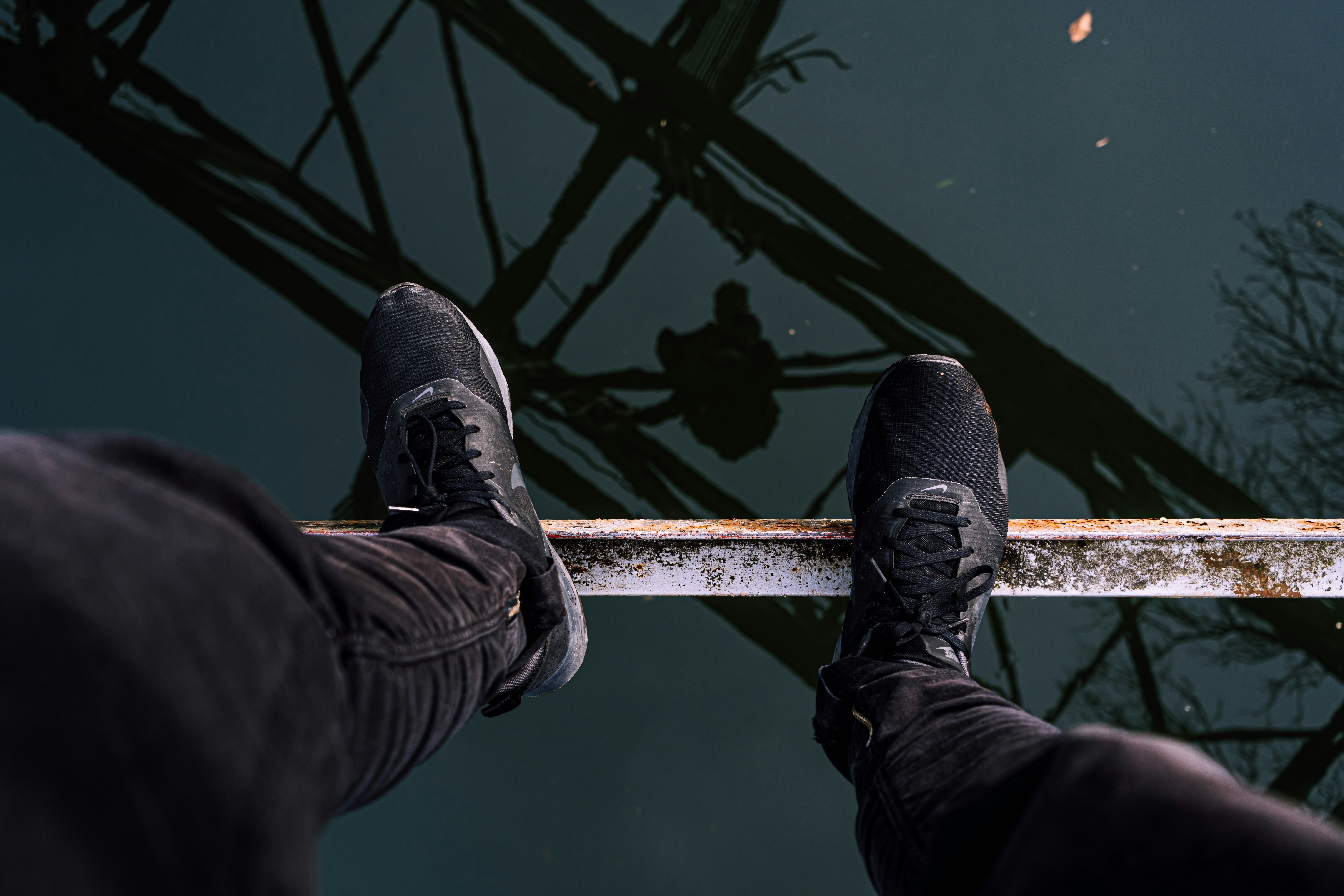 person standing on brown metal bar