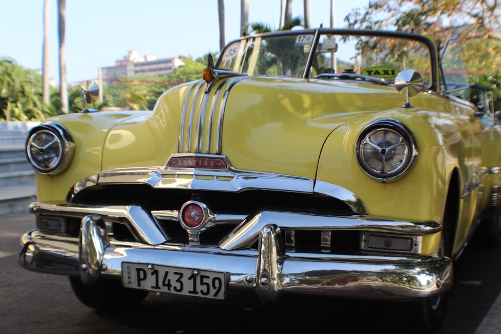 antique yellow coupe on road