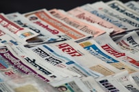 macro photography of assorted newspaper