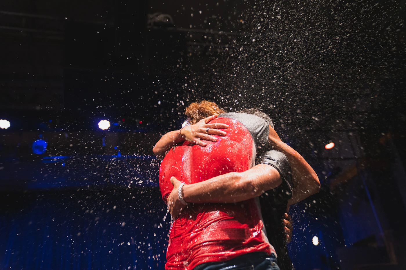 Two people embracing in the rain