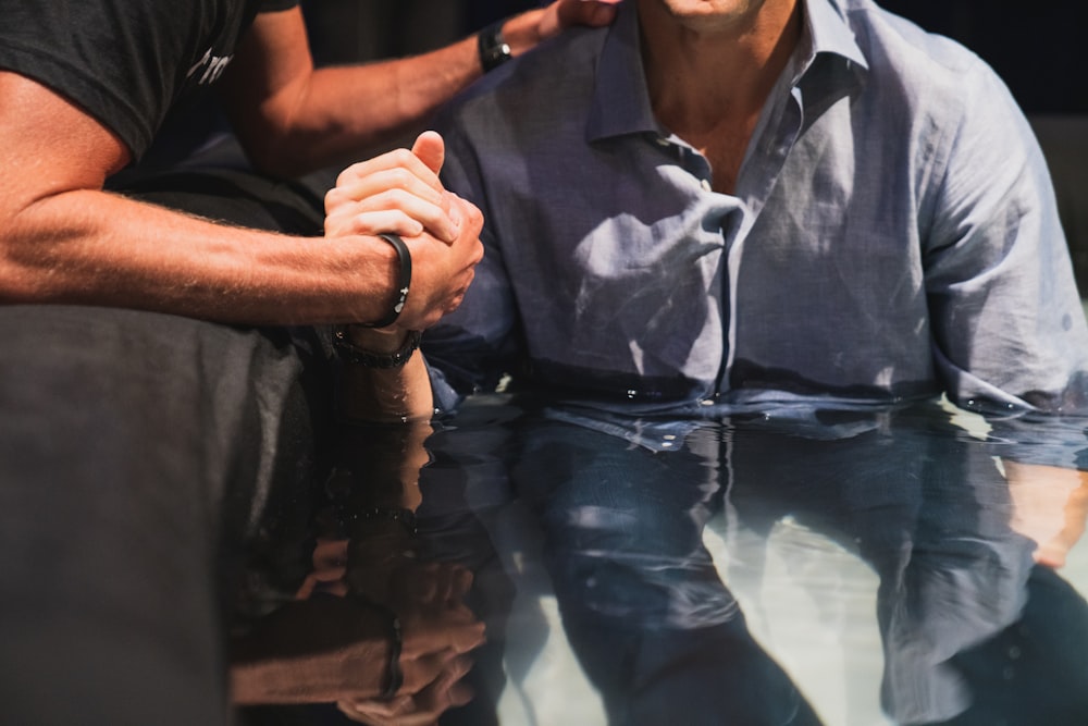 a man sitting at a table with his hand on his face