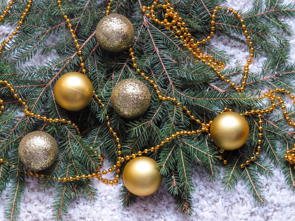 flat lay photography of gold Christmas baubles and tinsel