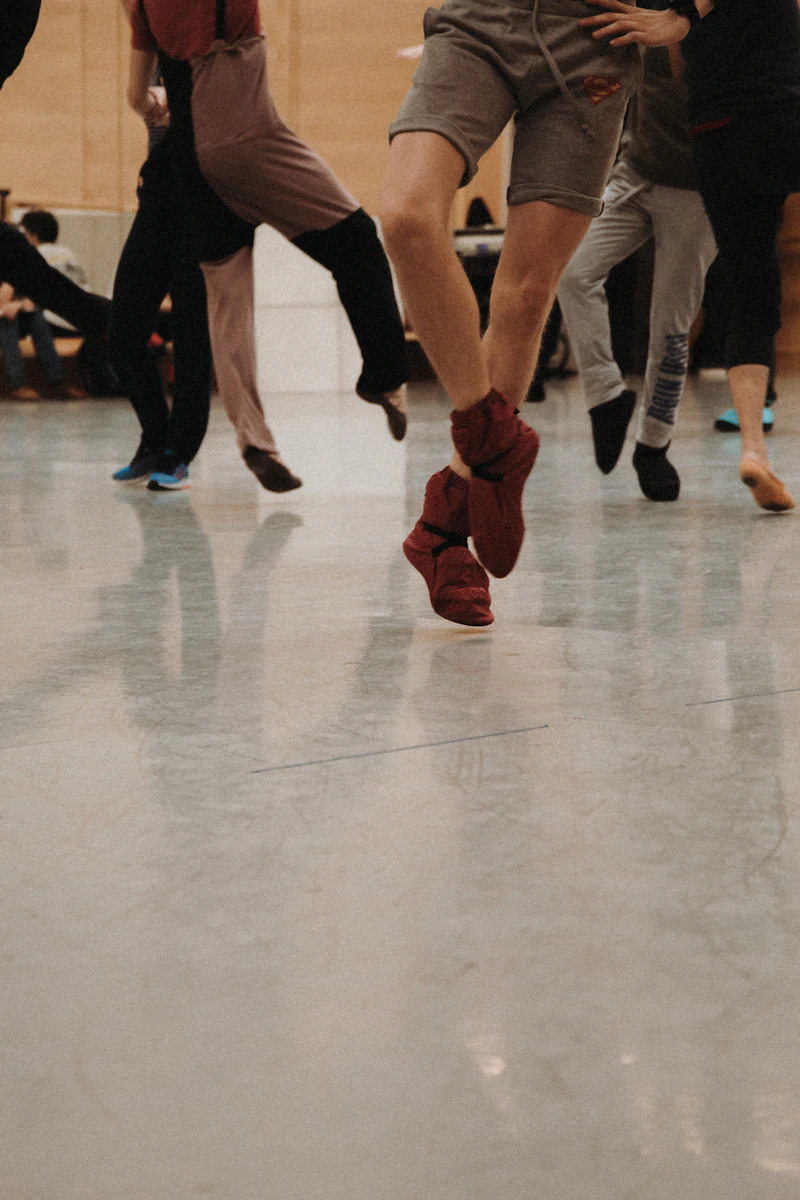 Close view of tap shoes in motion on a wooden studio floor