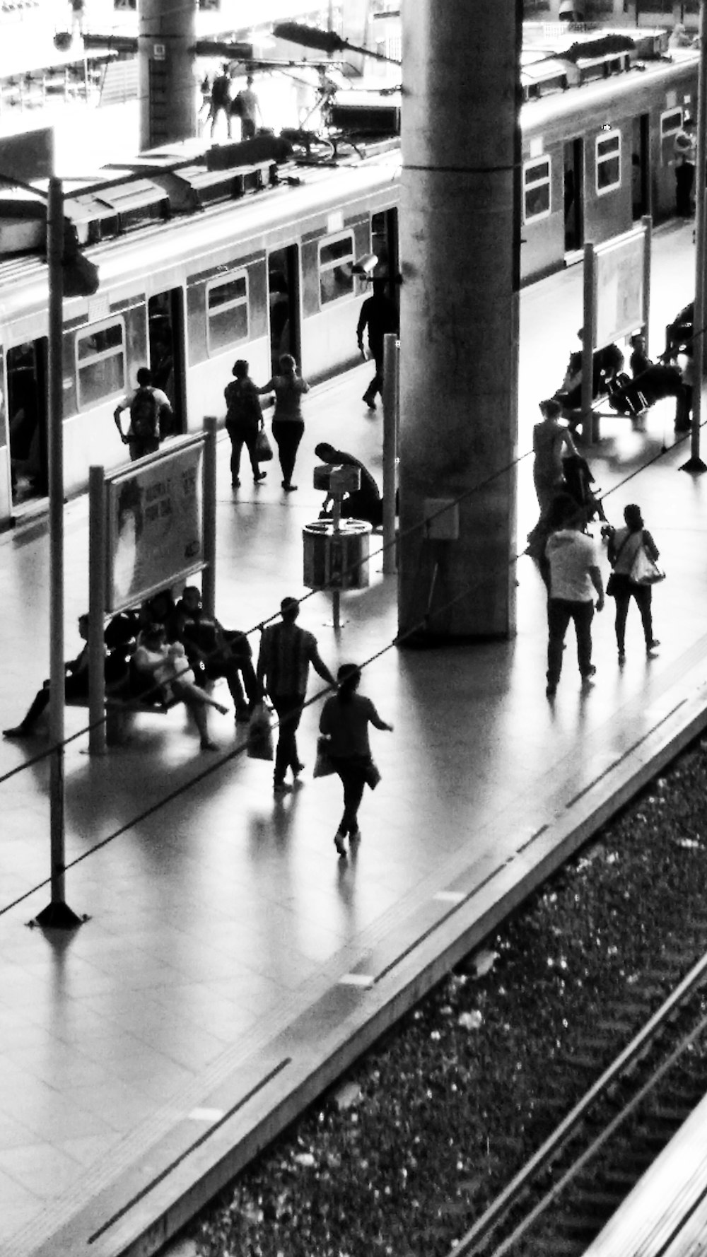 grayscale photo of people on train station