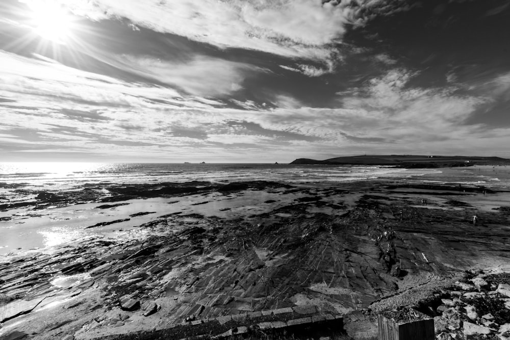 grayscale photography of mountain and river