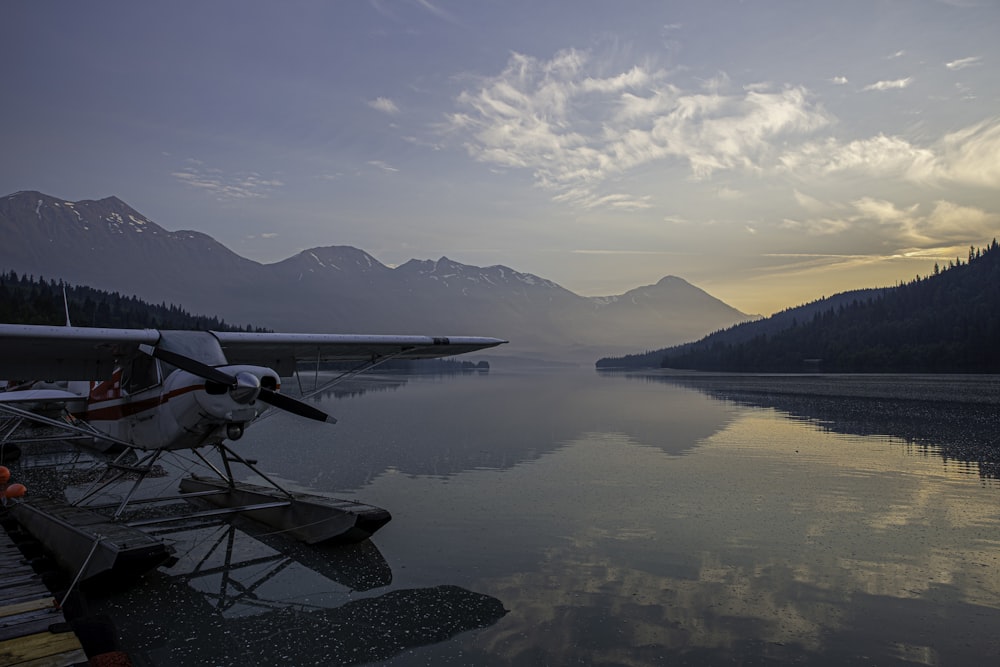 white plane on body of water