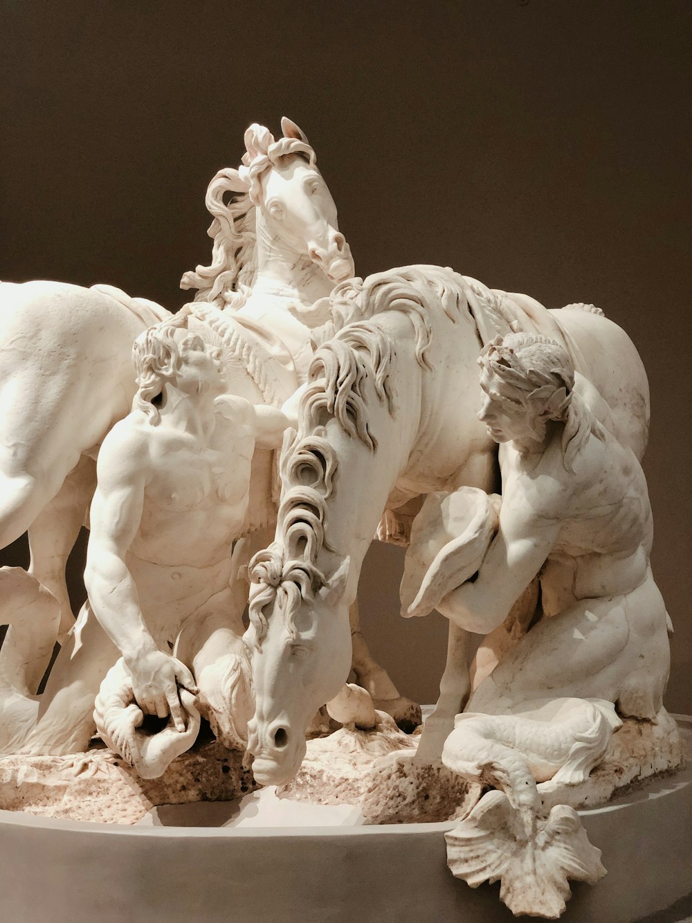 two men beside two horses ceramic figurine