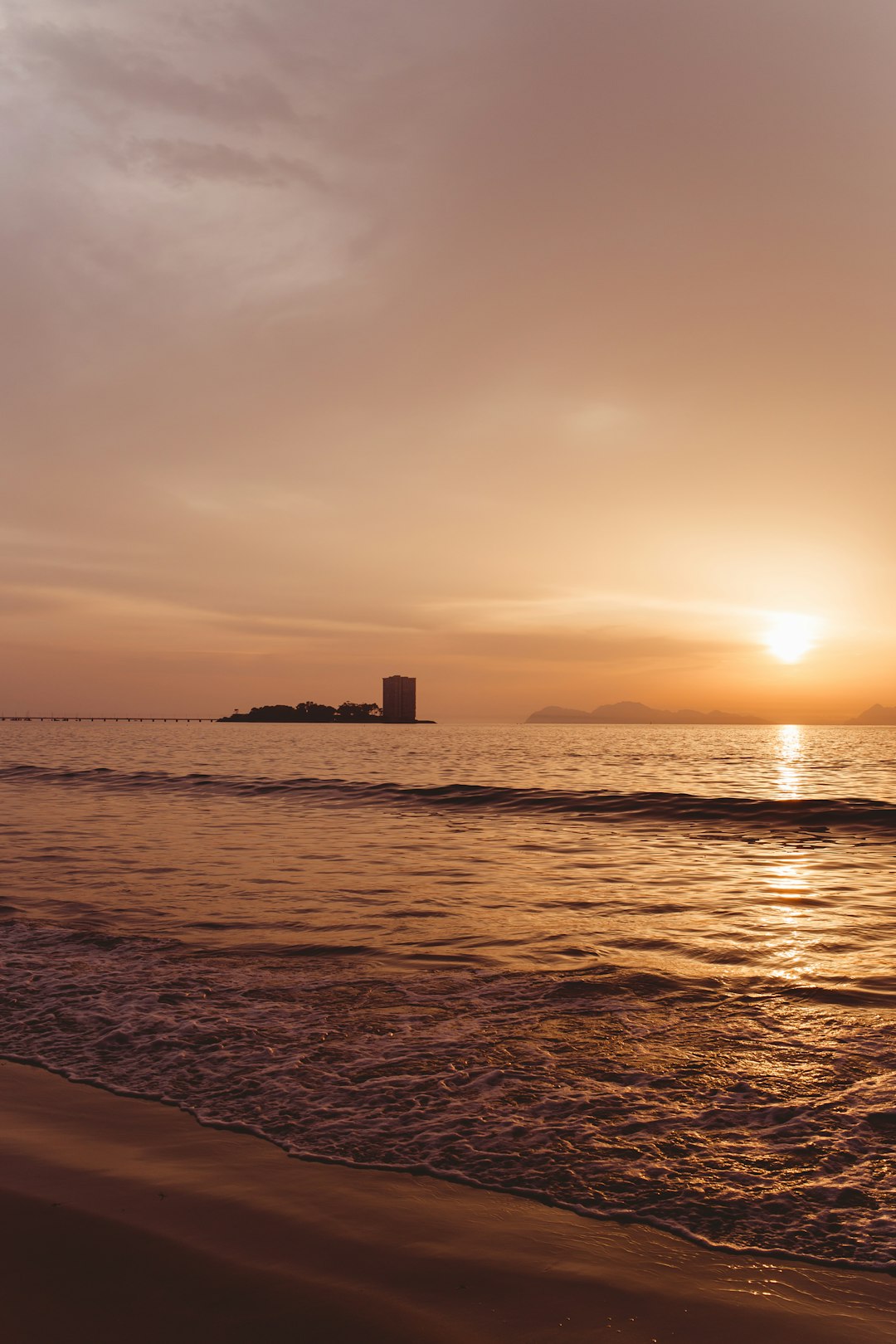 silhouette photography of an islet in the sea