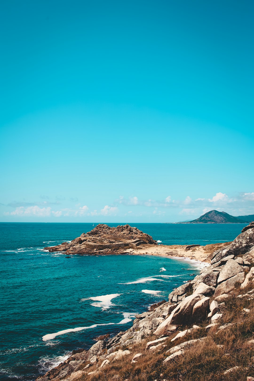 an islet in the beach during daytime