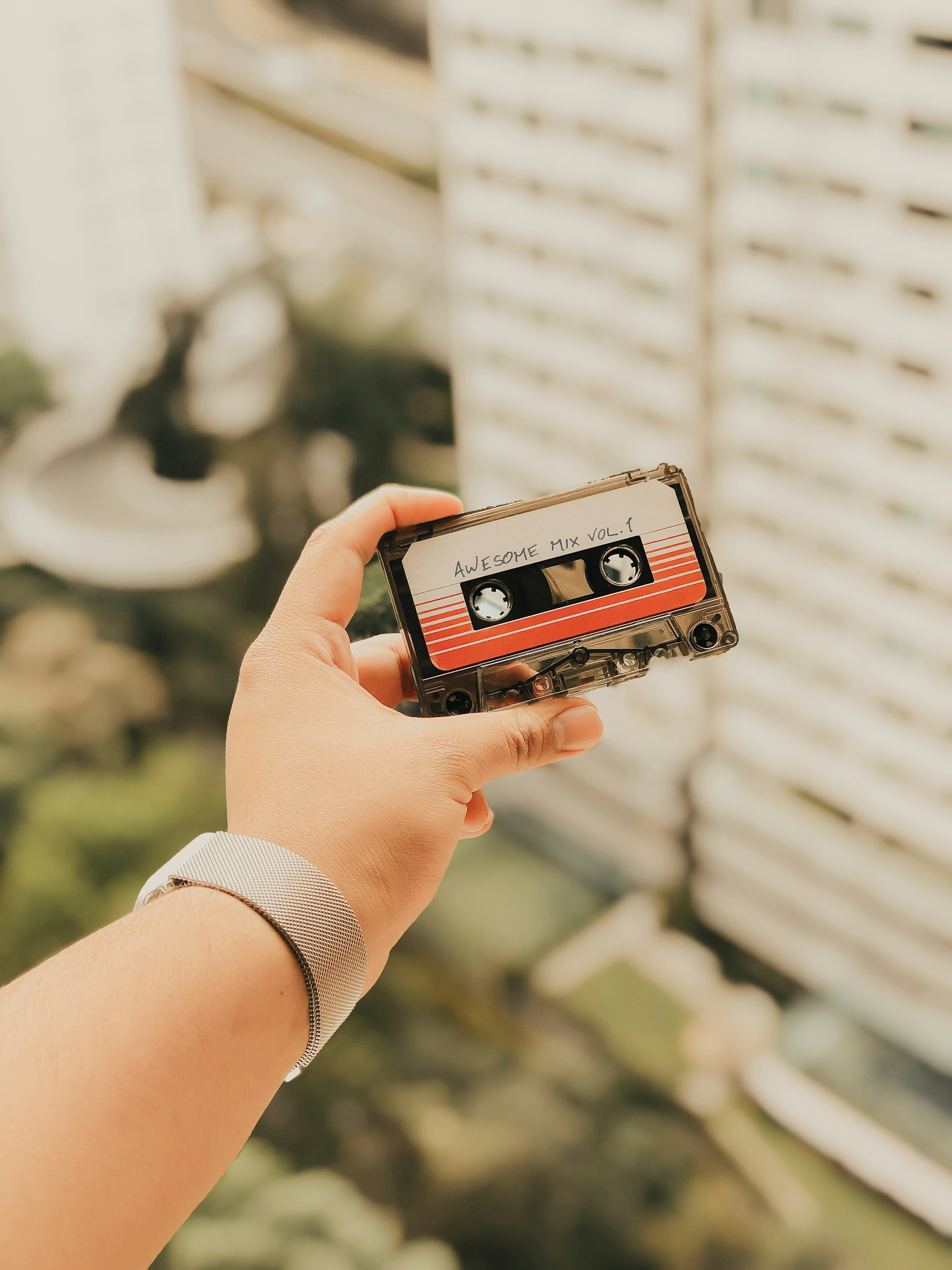 person holding cassette tape