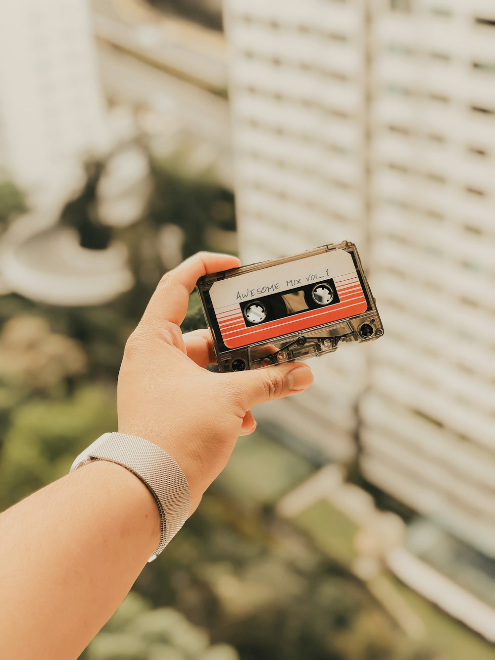 person holding cassette tape