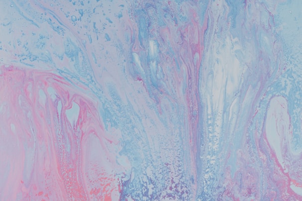 A vibrant abstract painting featuring a fluid mix of pastel colors. Swirling patterns of light blue, pink, and lavender create a dynamic and ethereal composition.