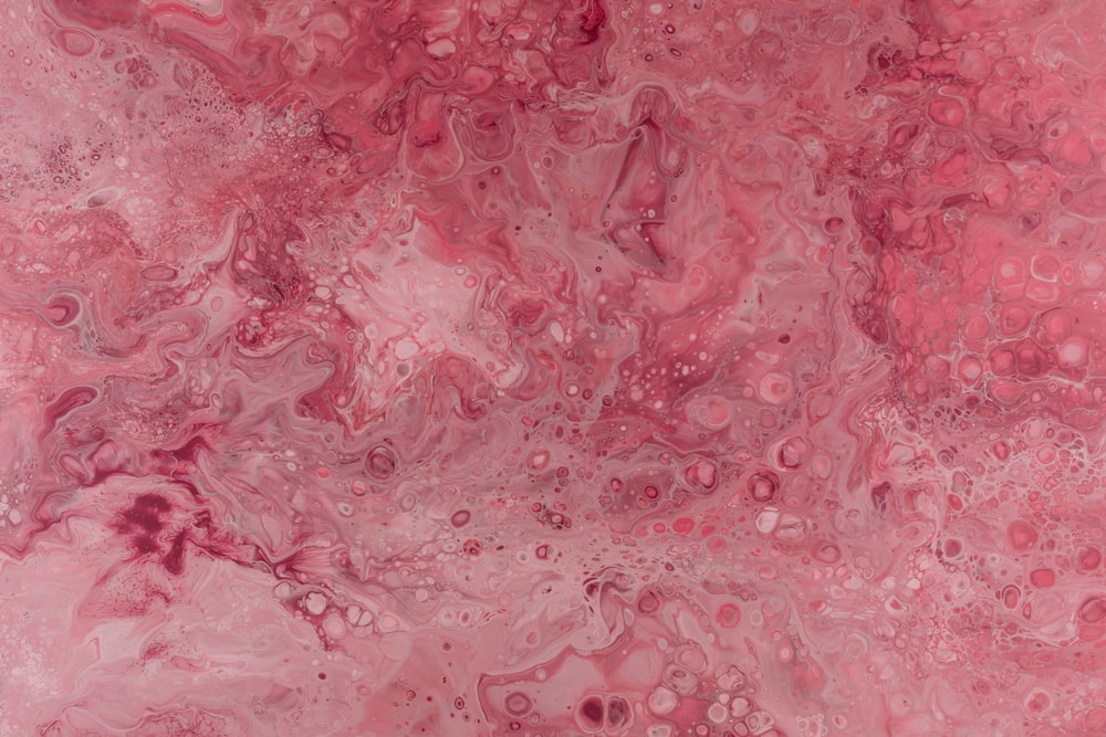 a close up of a pink and black marble