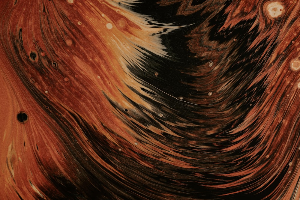 a close up of an abstract painting with brown and black colors