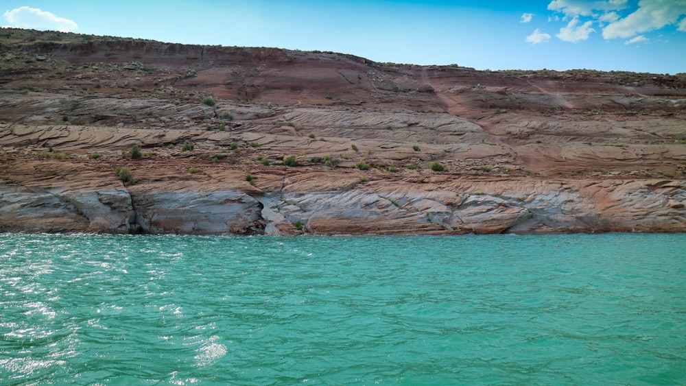 brown rock formation near sea water
