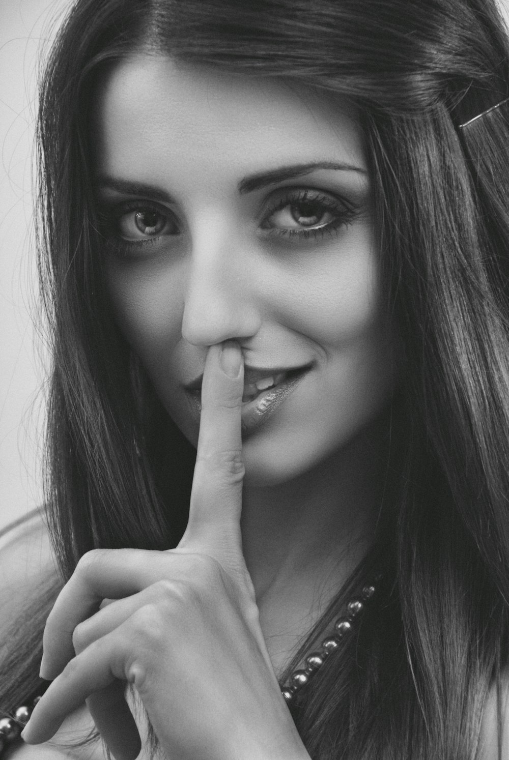a woman making a hush with her finger