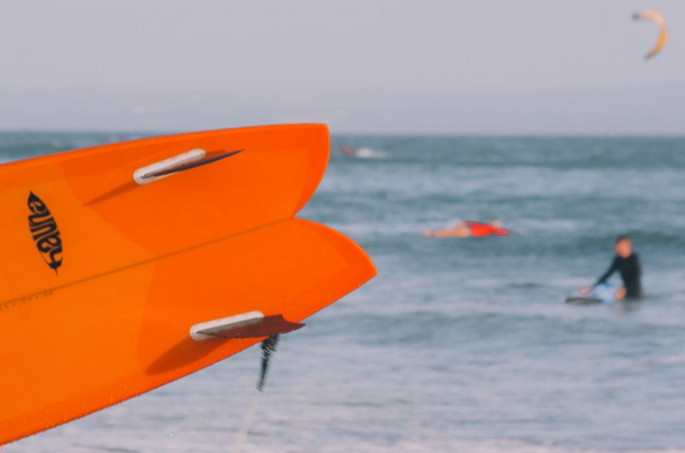 close-up photo of orange surfboard