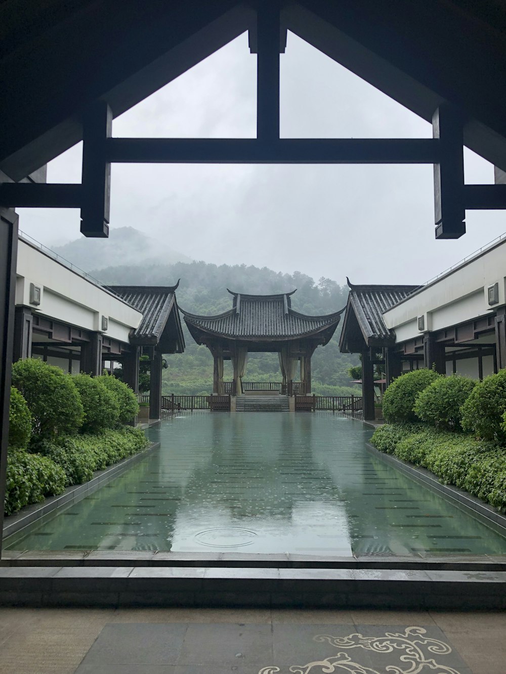 view photography of pond near plants and temple during daytime