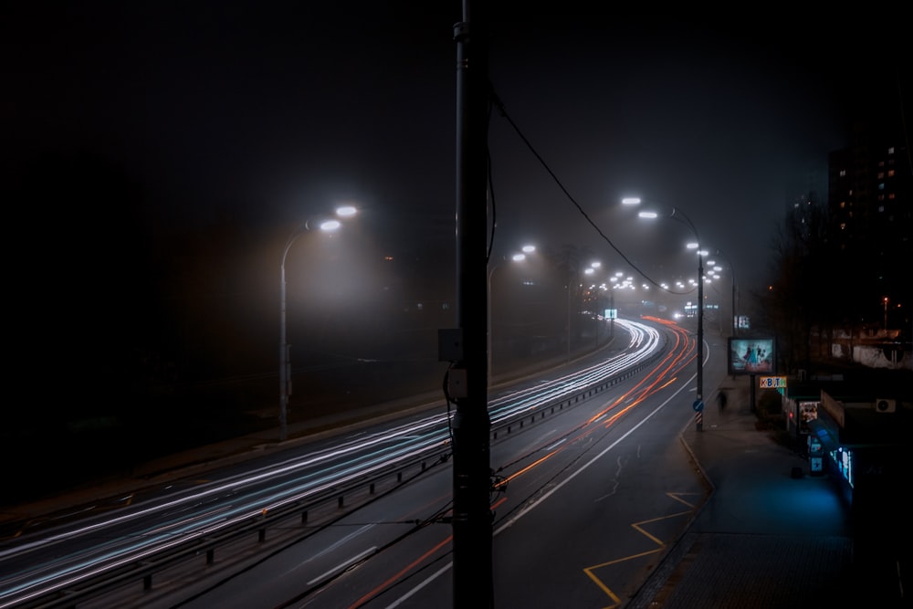 time lapse photography of vehicles travelling on road at night