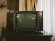 turned-off gray CRT TV on table