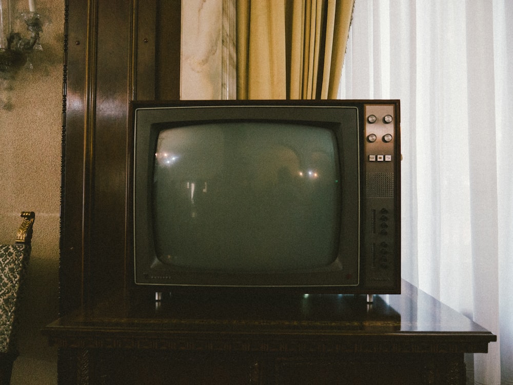 turned-off gray CRT TV on table