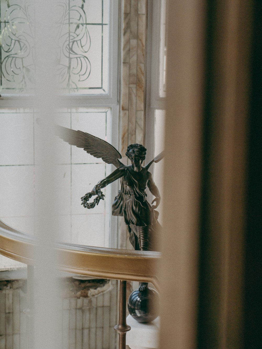 angel figurine near window