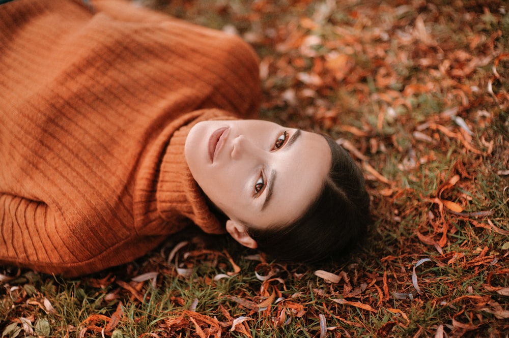 a woman laying on the ground with her eyes closed