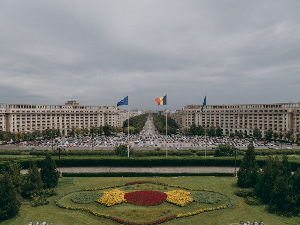 a large flower garden in front of a large building