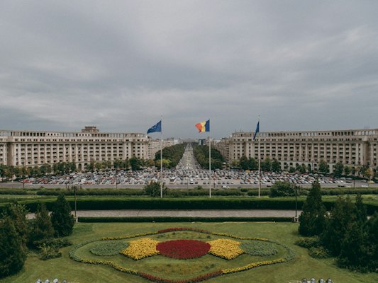 A large flower garden in front of a large building — Bucharest, Romania