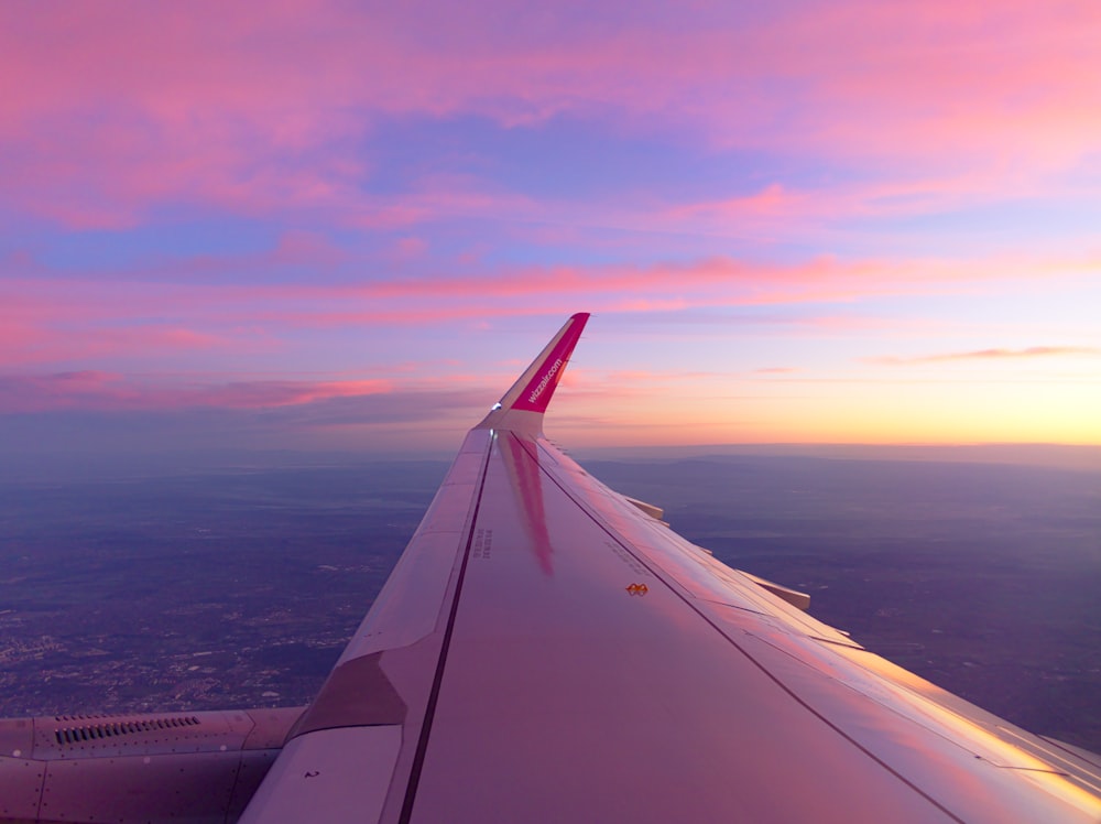 view photography of gray and red airplane wing