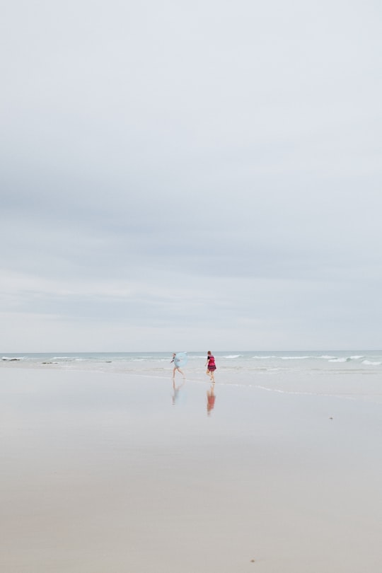 2 person on shore under white skies in Anglesea VIC Australia