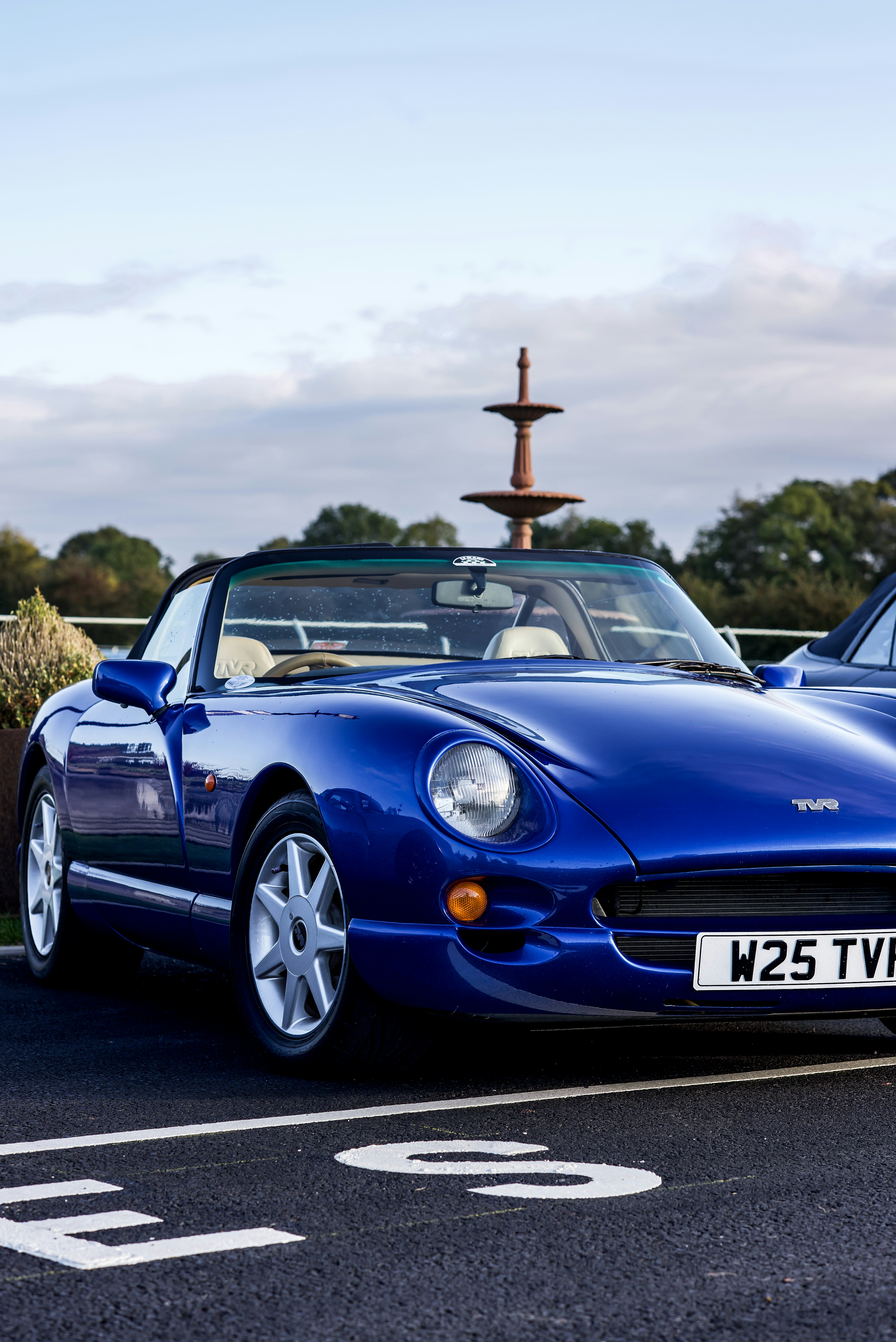 blue coupe on parked
