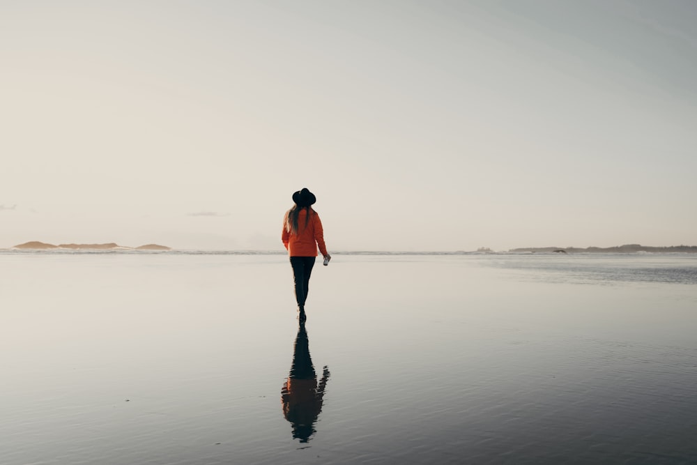 woman in red top walking on beach