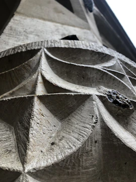 Close-up of finely carved stone sculptures and tiles arranged artistically in a sunlit workshop.