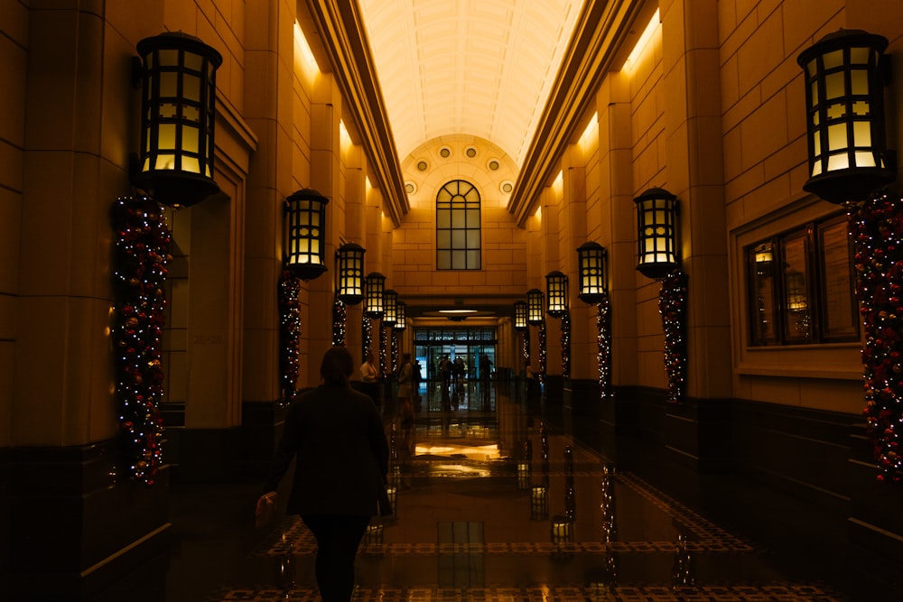 person walking on lighted hallway