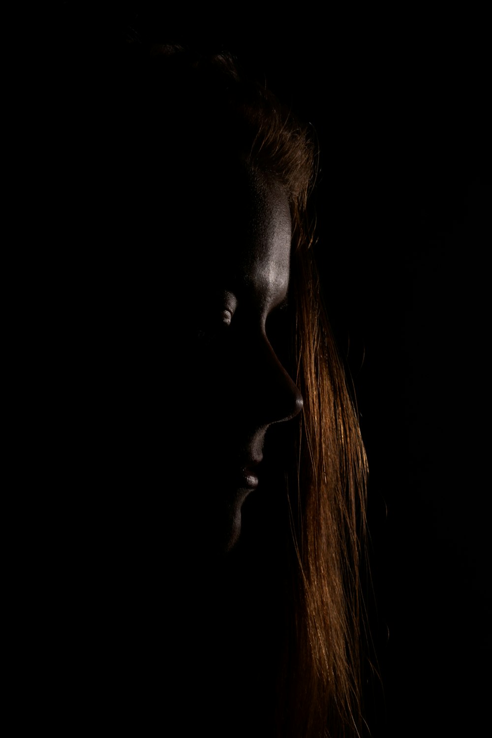 a woman with long hair in the dark