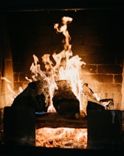 A warm fireplace glowing in a cozy living room after chimney service.