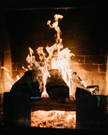 Close-up of a clean, well-maintained fireplace glowing warmly inside a cozy Fort Worth home.