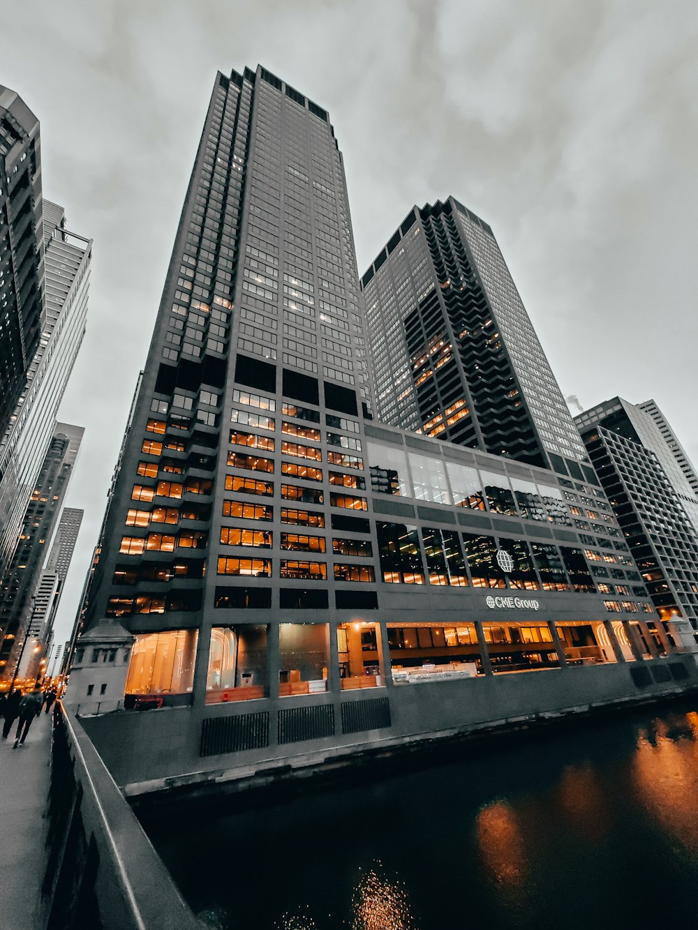 glass walled high rise building near body of water