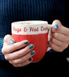 person holding white and red ceramic mug