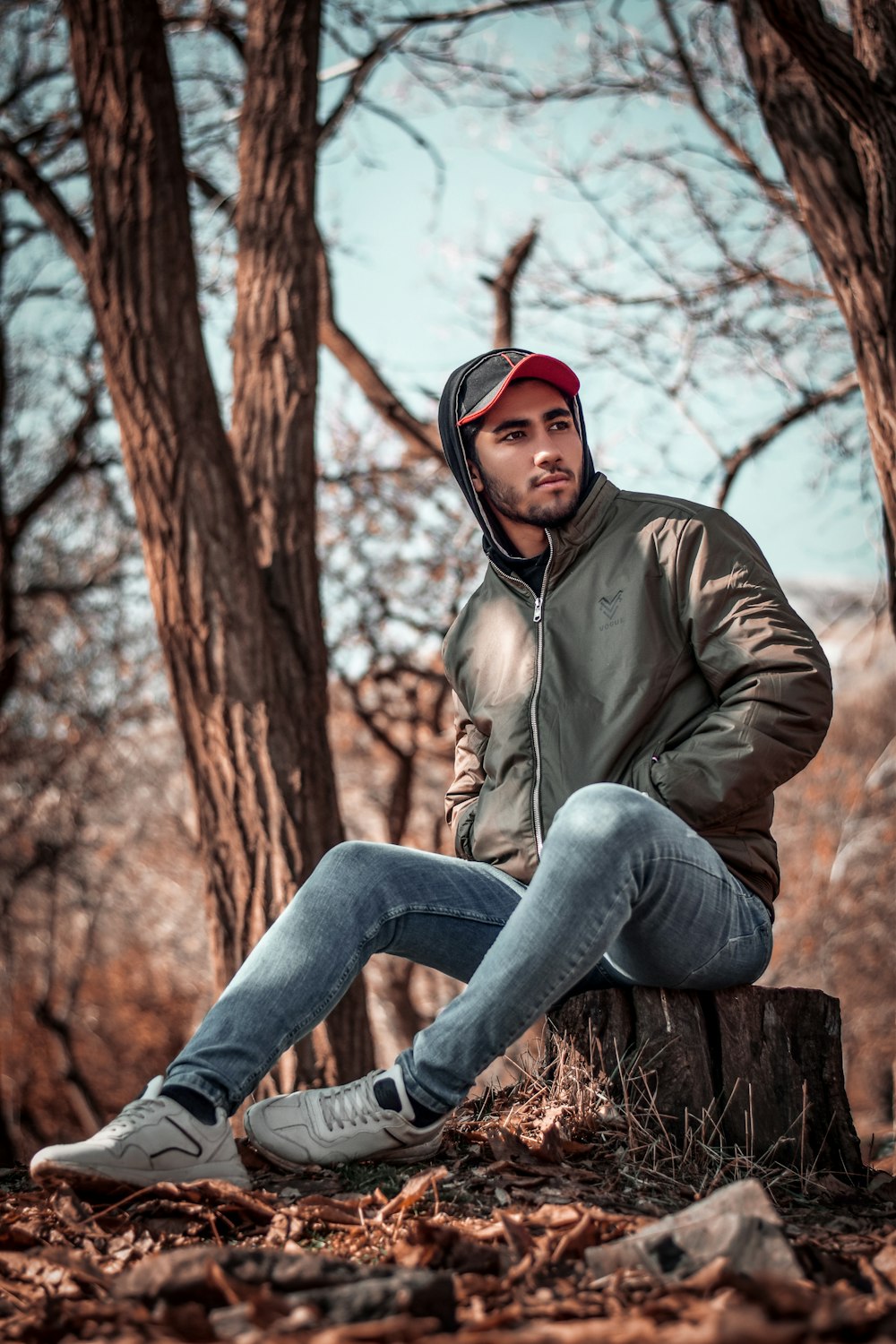 man sitting on cuted tree