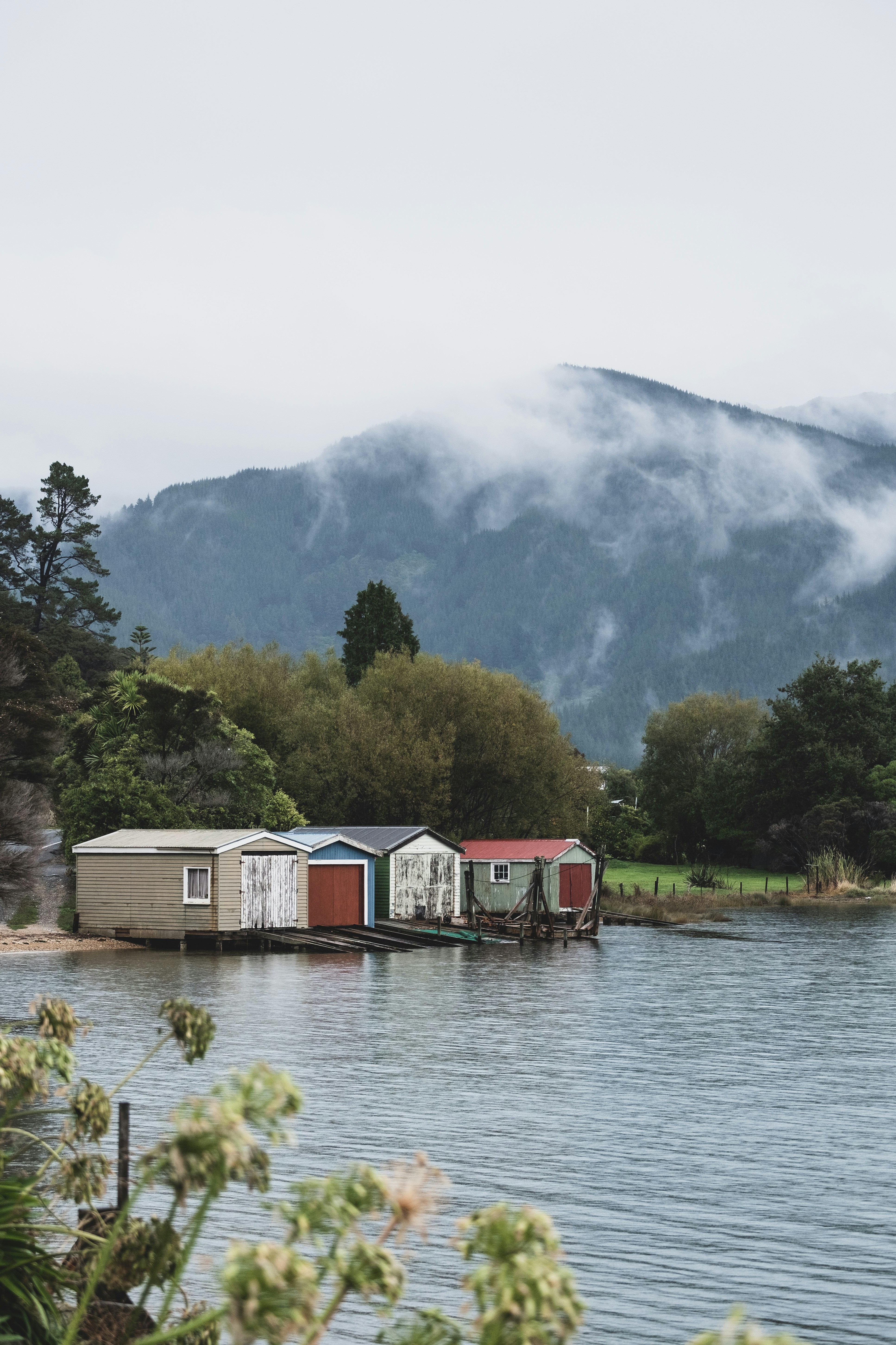 white and red log house near at seashore