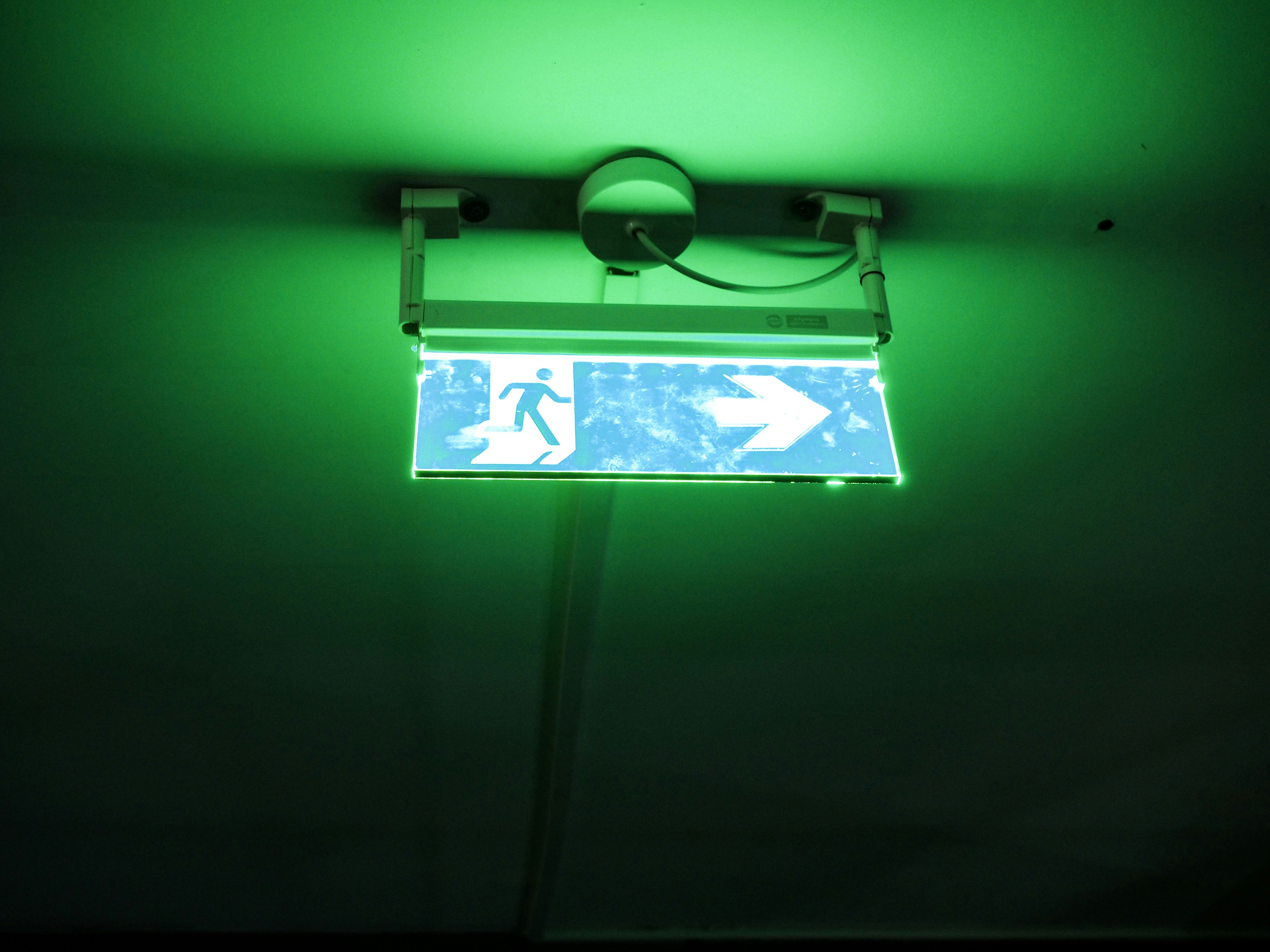 a street sign is lit up in the dark