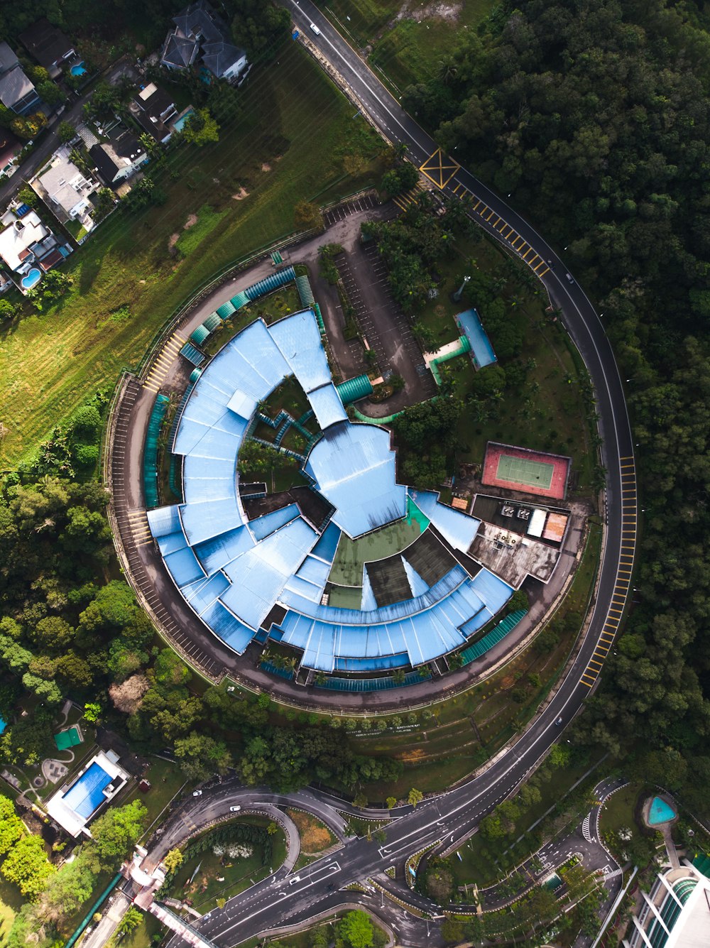 aerial photograph of blue structure on hill