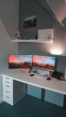 Modern desktop computer setup with dual monitors on a clean desk.